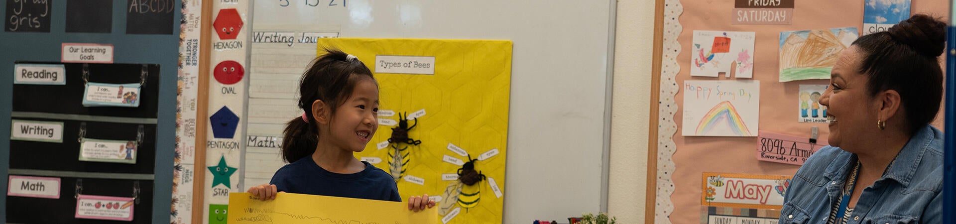 kindergartener smiling while presenting to class